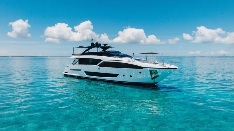 Slide: The Image of Luxury 2020 Riva 90 Argo yacht on clear blue ocean under a bright sky. - 1