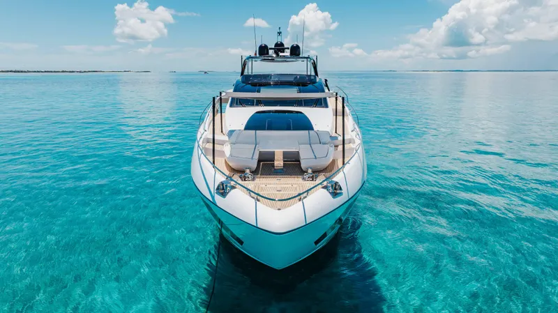 Slide: The Image of Luxurious 2020 Riva 90 Argo yacht on clear turquoise waters under a bright blue sky. - 4
