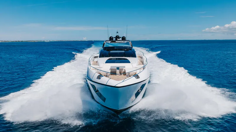 Slide: The Image of Luxury 2020 Riva 90 Argo yacht cruising on open blue sea. - 5