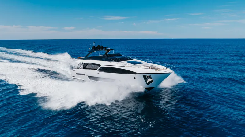 Slide: The Image of Luxury Riva 90 Argo yacht cruising on open sea, 2020 model, under clear blue sky. - 6
