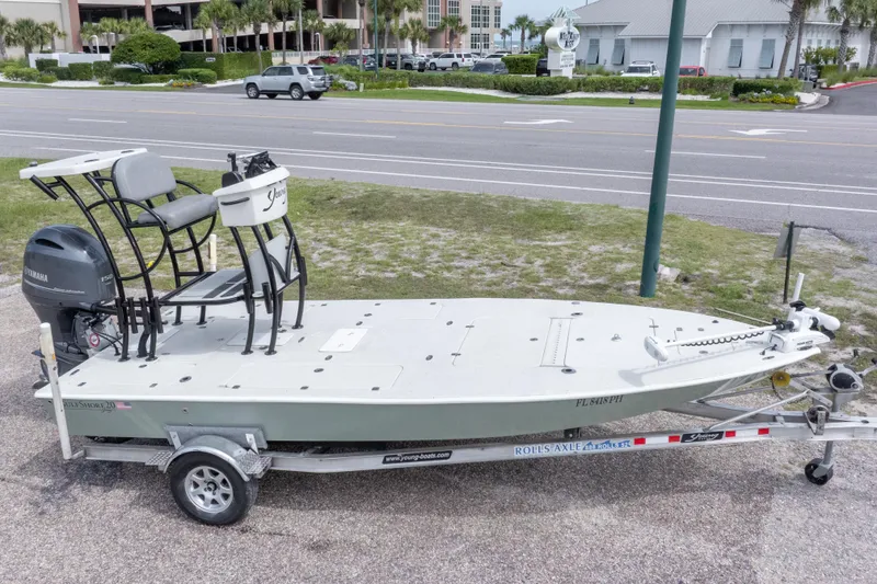 Slide: The Image of 2012 Young GulfShore 20 boat on trailer, parked near a road. - 1