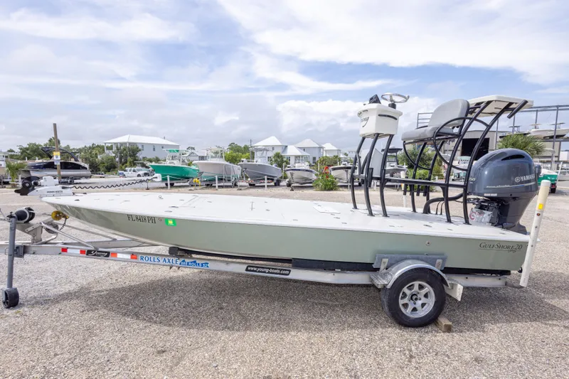 Slide: The Image of 2012 Young GulfShore 20 boat on trailer with Yamaha engine, parked outdoors. - 17