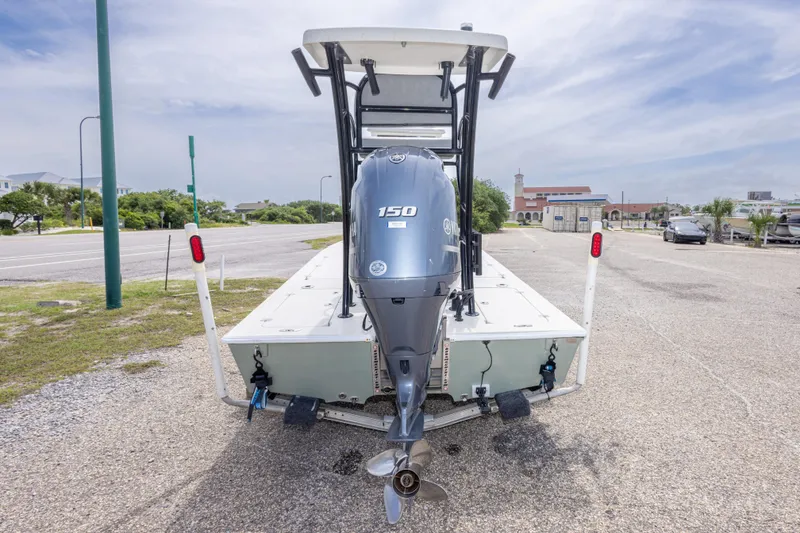 Slide: The Image of 2012 Young GulfShore 20 boat with 150 HP engine in a parking lot. - 18