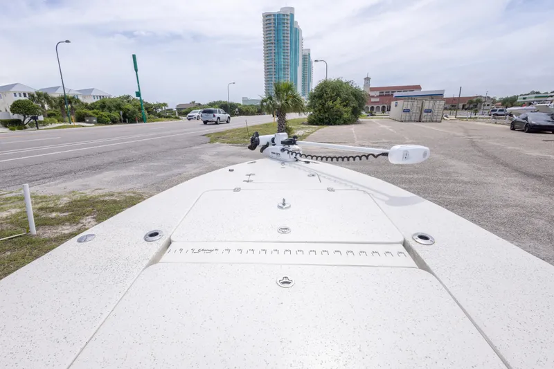 Slide: The Image of 2012 Young GulfShore 20 boat parked near a road with buildings in the background. - 26
