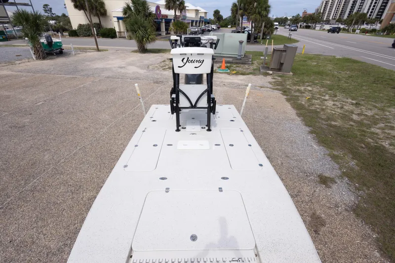 Slide: The Image of 2012 Young GulfShore 20 boat parked on a coastal road with palm trees. - 27
