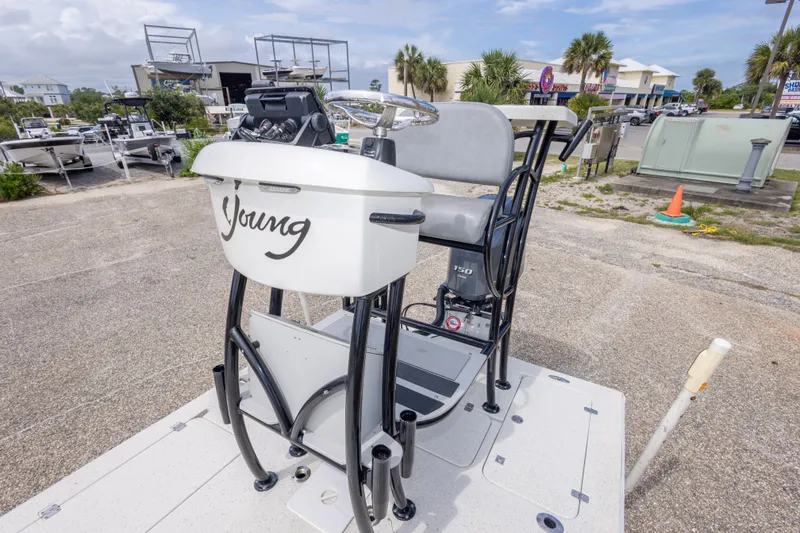Slide: The Image of 2012 Young GulfShore 20 boat console in a marina setting, showcasing steering and controls. - 29