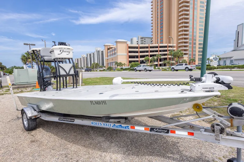 Slide: The Image of 2012 Young GulfShore 20 boat on trailer, parked near high-rise buildings. - 3