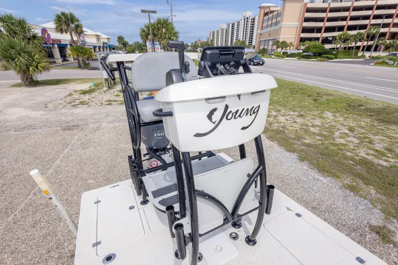Slide: The Image of 2012 Young GulfShore 20 boat parked near a road with palm trees and buildings. - 30