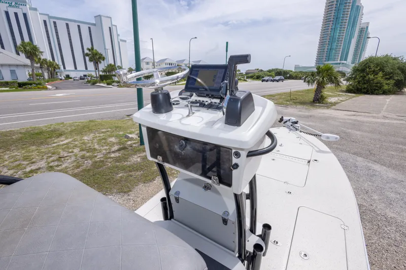 Slide: The Image of 2012 Young GulfShore 20 boat console with navigation equipment, parked near a coastal road. - 31