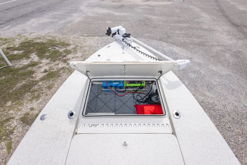 Slide: The Image of Open storage compartment on 2012 Young GulfShore 20 boat, showing battery and wiring. - 35