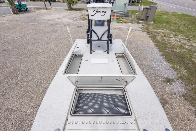 Slide: The Image of 2012 Young GulfShore 20 boat with open storage compartments, parked on gravel. - 36