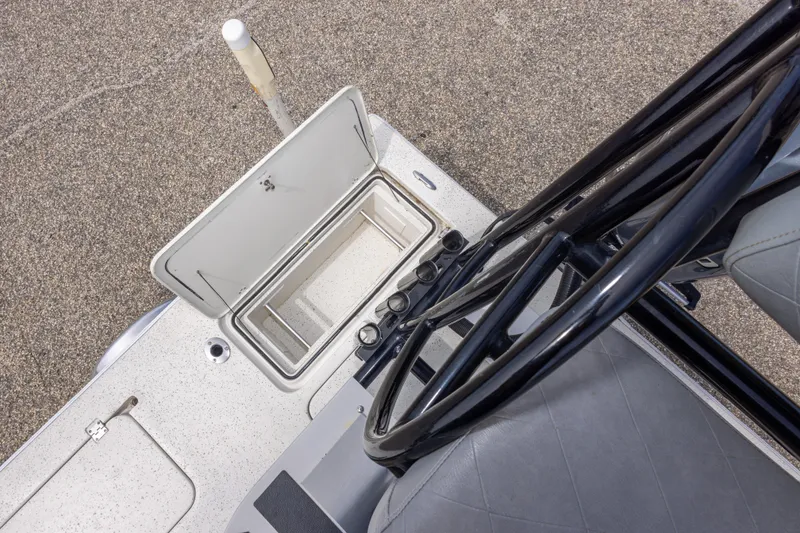 Slide: The Image of 2012 Young GulfShore 20 boat interior with open storage compartment and steering wheel. - 41