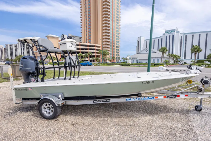 Slide: The Image of 2012 Young GulfShore 20 boat on trailer, parked near high-rise buildings. - 5