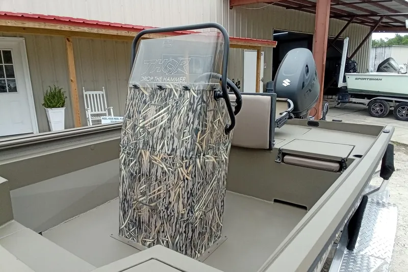 Slide: The Image of 2026 Thor 1900 Lake Hammer boat with camouflage console and Suzuki outboard motor. - 34