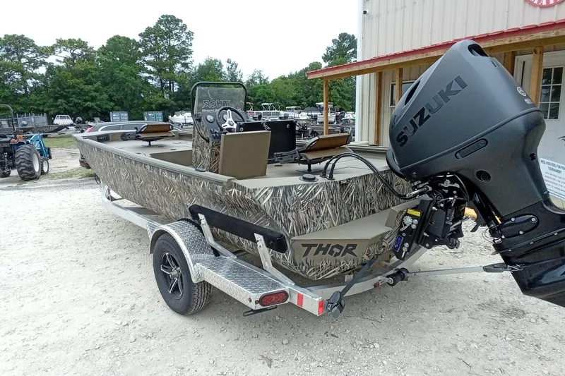 Slide: The Image of 2026 Thor 1900 Lake Hammer boat with Suzuki engine, parked outdoors on a trailer. - 39