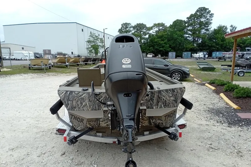 Slide: The Image of Rear view of 2026 Thor 1900 Lake Hammer boat with camouflage design in outdoor setting. - 40