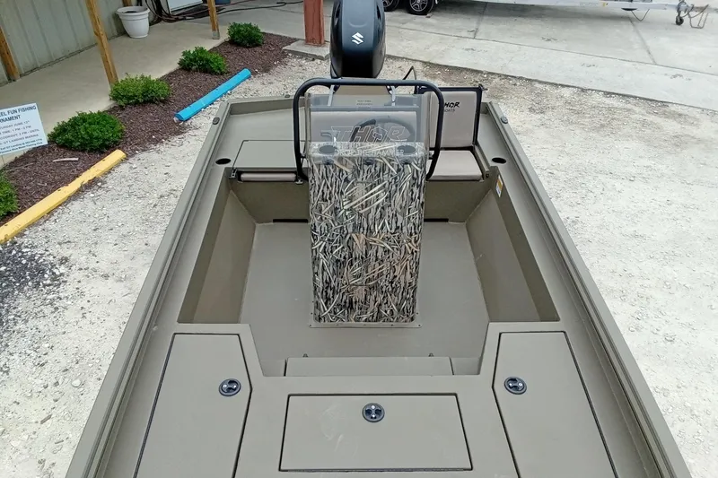 Slide: The Image of 2026 Thor 1900 Lake Hammer boat interior with camouflage seat and storage compartments. - 45