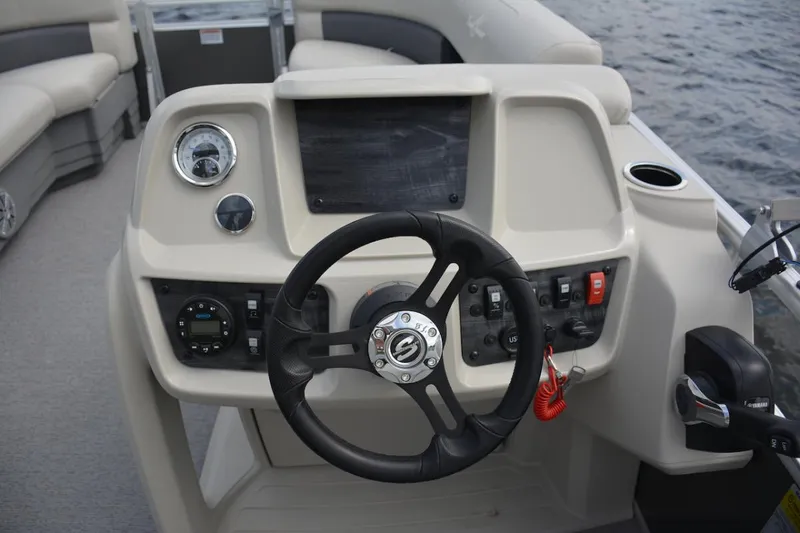 Slide: The Image of Manufacturer Provided Image: 2024 SunChaser Vista 18 LR boat dashboard with steering wheel and control panel. - 12
