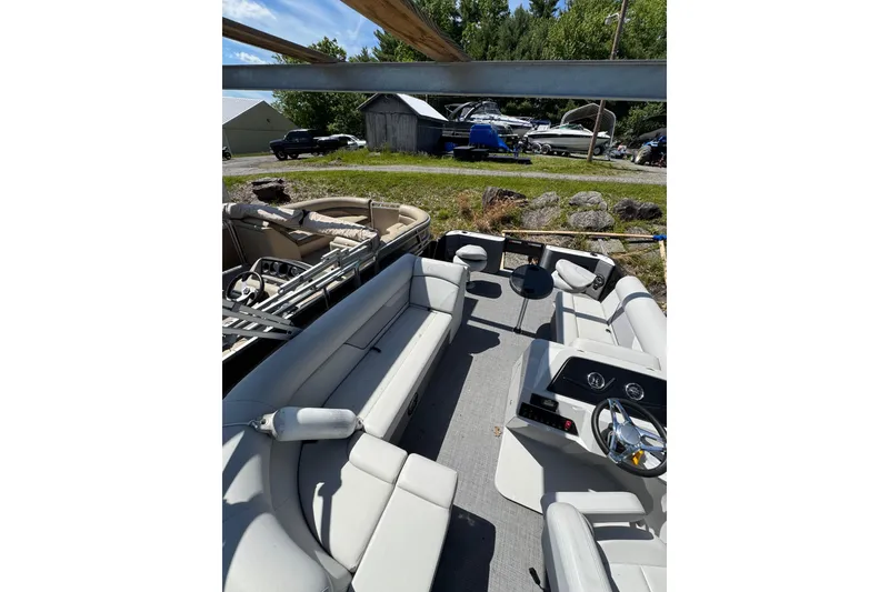 Slide: The Image of 2023 Crest CLASSIC LX FISH 200 C4 pontoon boat interior with seating and steering console. - 6