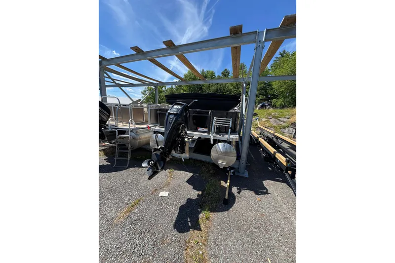 Slide: The Image of 2023 Crest CLASSIC LX FISH 200 C4 pontoon boat with outboard motor, parked outdoors. - 7