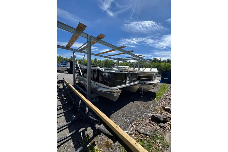 Slide: The Image of 2023 Crest CLASSIC LX FISH 200 C4 pontoon boats in outdoor storage. - 8