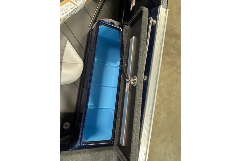 Slide: The Image of Interior storage compartment of 2026 Nitro ZV21 Pro boat, featuring blue lining and secure latch. - 11