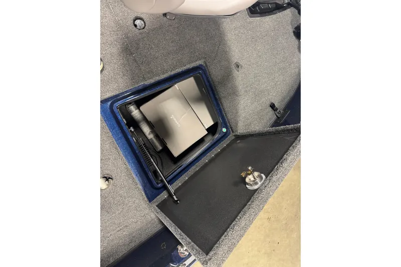 Slide: The Image of Open storage compartment in 2026 Nitro ZV21 Pro boat, featuring a Garmin device. - 16