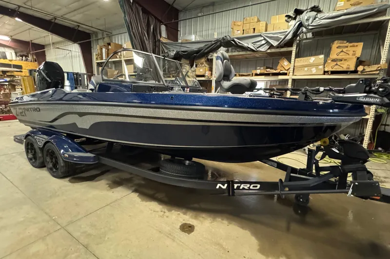 Slide: The Image of 2026 Nitro ZV21 Pro boat in a warehouse, featuring a sleek blue design. - 2