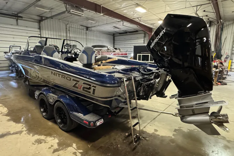 Slide: The Image of 2026 Nitro ZV21 Pro boat with Mercury engine in a garage setting. - 4