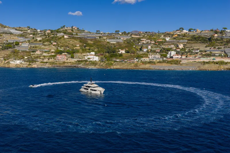 Slide: The Image of 2023 Cantiere Delle Marche RJ 115 yacht cruising near scenic coastal hillside. - 1