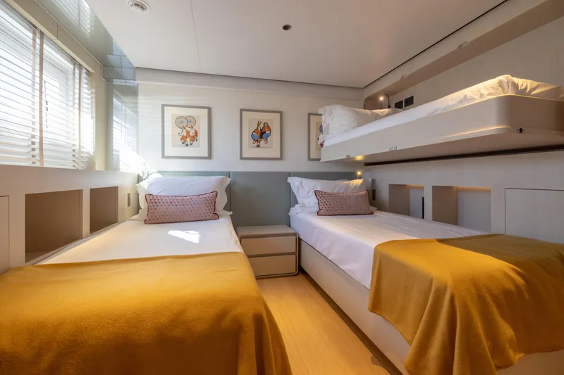 Slide: The Image of Luxurious 2023 Cantiere Delle Marche RJ 115 yacht cabin with twin beds and modern decor. - 27