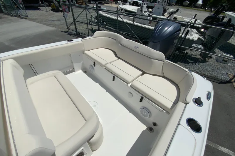 Slide: The Image of 2024 Sea Hunt Ultra 234 boat interior with cushioned seating and storage compartments. - 12