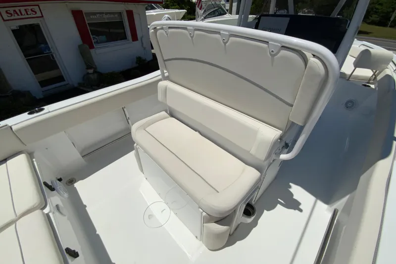 Slide: The Image of 2024 Sea Hunt Ultra 234 boat interior with cushioned seating and sleek design. - 13