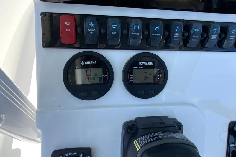 Slide: The Image of Control panel of a 2024 Sea Hunt Ultra 234 boat with Yamaha gauges. - 16