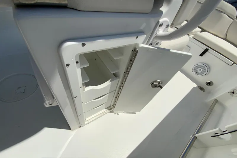Slide: The Image of Open storage compartment on 2024 Sea Hunt Ultra 234 boat, showcasing interior space. - 19