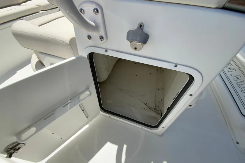 Slide: The Image of Open storage compartment on 2024 Sea Hunt Ultra 234 boat deck. - 20