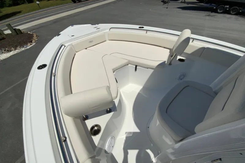 Slide: The Image of 2024 Sea Hunt Ultra 234 boat interior with cushioned seating and sleek design. - 22