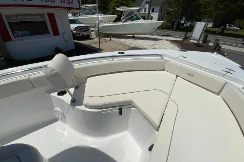Slide: The Image of 2024 Sea Hunt Ultra 234 boat interior with cushioned seating and modern design. - 23