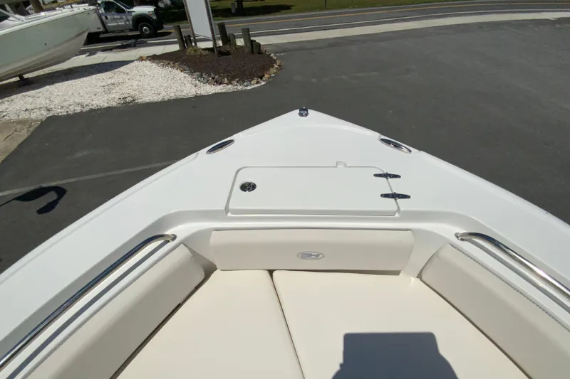 Slide: The Image of 2024 Sea Hunt Ultra 234 boat bow with seating and storage compartment. - 24