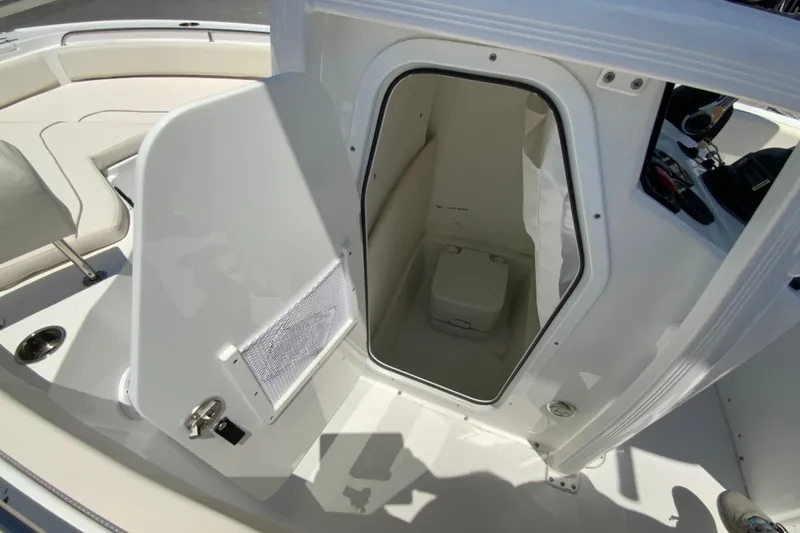 Slide: The Image of 2024 Sea Hunt Ultra 234 boat interior with open storage compartment. - 28