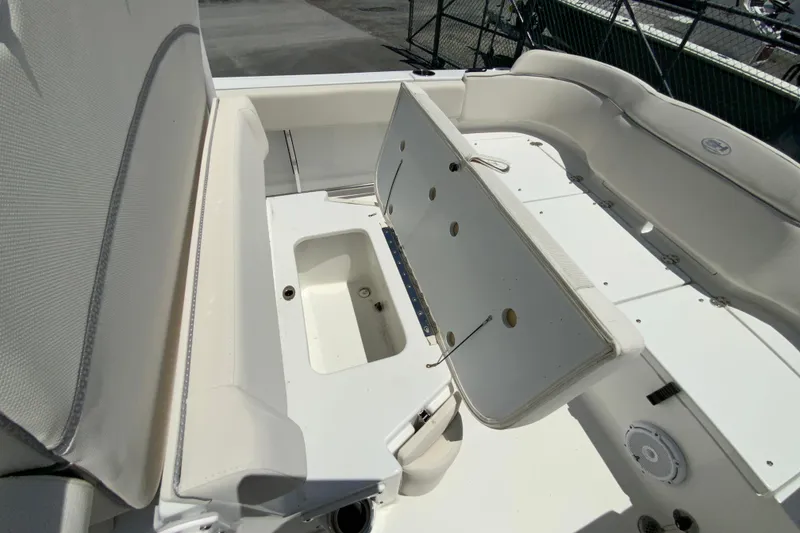 Slide: The Image of 2024 Sea Hunt Ultra 234 boat interior with open storage compartment. - 33
