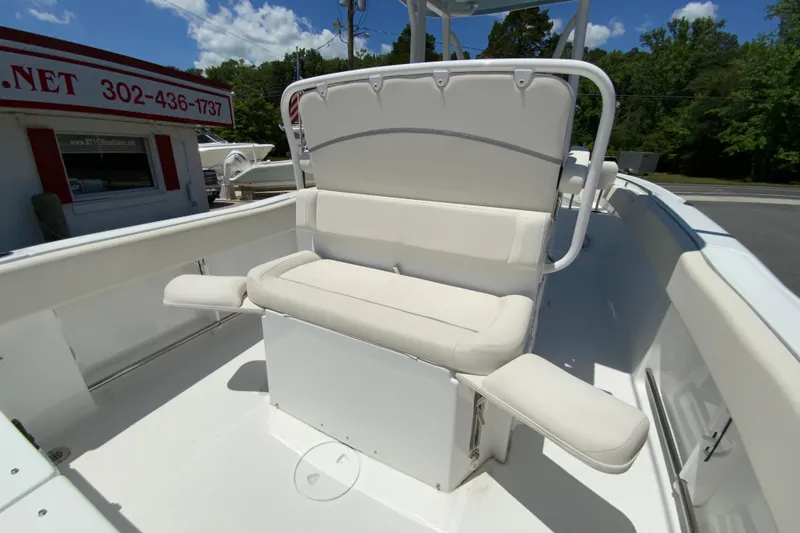 Slide: The Image of 2024 Sea Hunt Ultra 234 boat interior with cushioned seating and armrests. - 34