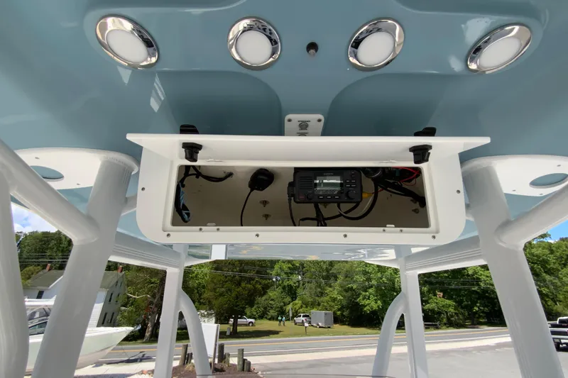 Slide: The Image of 2024 Sea Hunt Ultra 234 boat console with electronic equipment and overhead lighting. - 35