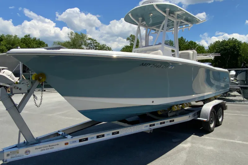 Slide: The Image of 2024 Sea Hunt Ultra 234 boat on trailer under blue sky. - 5