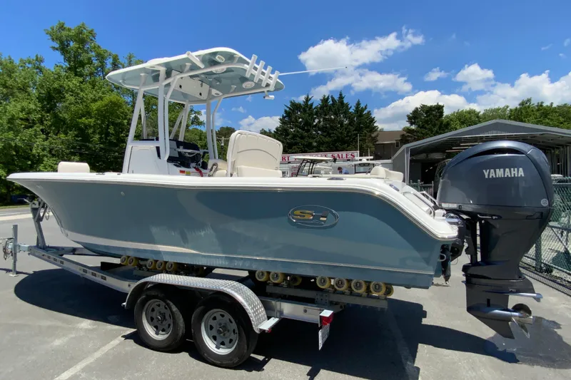 Slide: The Image of 2024 Sea Hunt Ultra 234 boat with Yamaha engine on trailer, outdoors. - 7