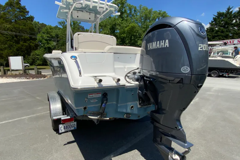 Slide: The Image of 2024 Sea Hunt Ultra 234 boat with Yamaha 200 engine, parked outdoors. - 8