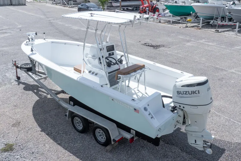 Slide: The Image of 1998 Contender 21 CC boat on trailer with Suzuki outboard motor. - 14