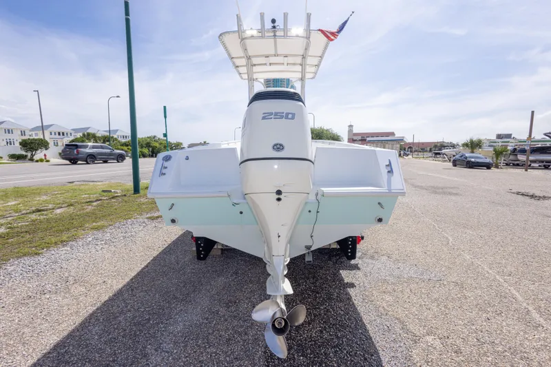 Slide: The Image of 1998 Contender 21 CC boat with powerful outboard motor, parked on a sunny day. - 15