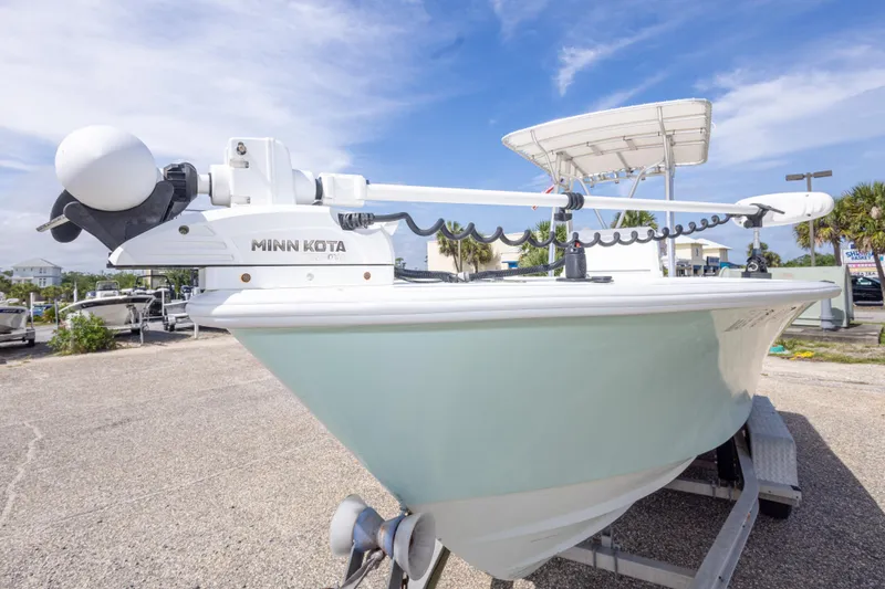 Slide: The Image of 1998 Contender 21 CC boat with Minn Kota trolling motor on trailer, under clear sky. - 18