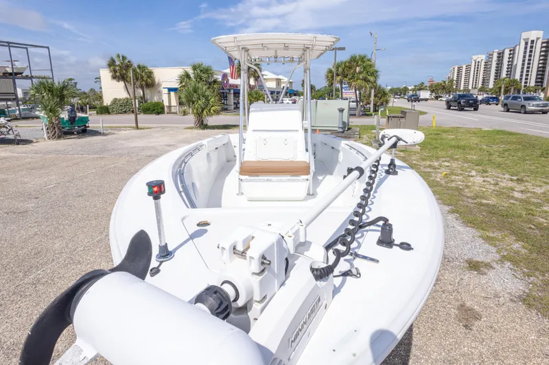 Slide: The Image of 1998 Contender 21 CC boat parked on a sunny street with palm trees. - 20